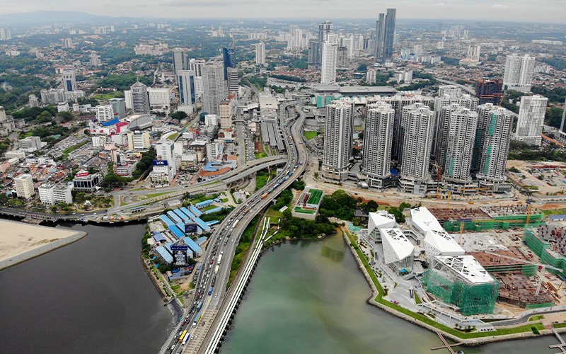 Aerial view of Johor Bahru city with causeway traffic.