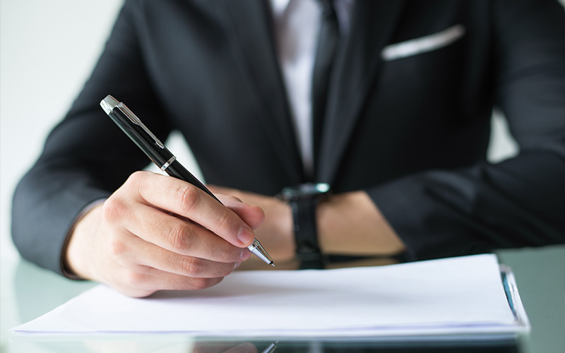 Businessman signing a car leasing contract.