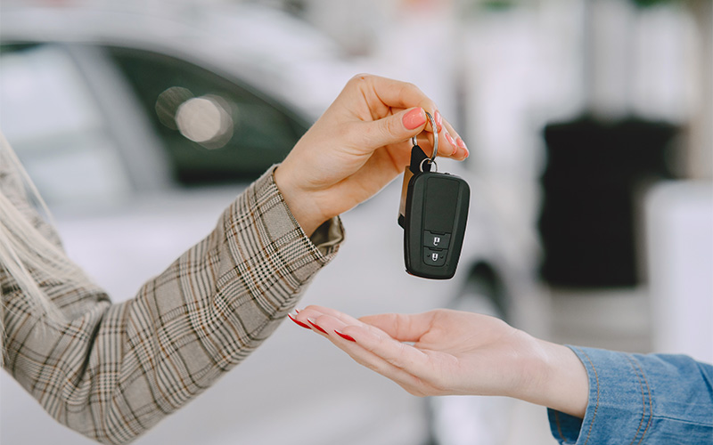 Close Up Of Hands Exchanging Car Keys