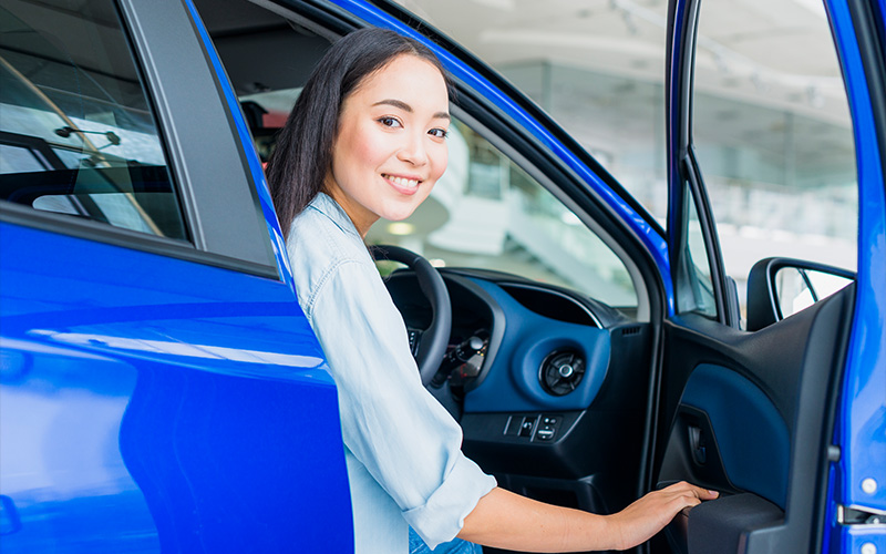 Employee happy with her new corporate leased car.