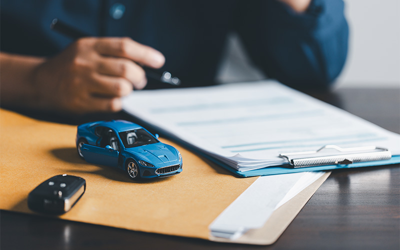 Businessman signing a car leasing contract.